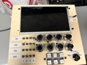 Image of RTD test, a cream colored box with mutiple switches, knobs and an LCD.